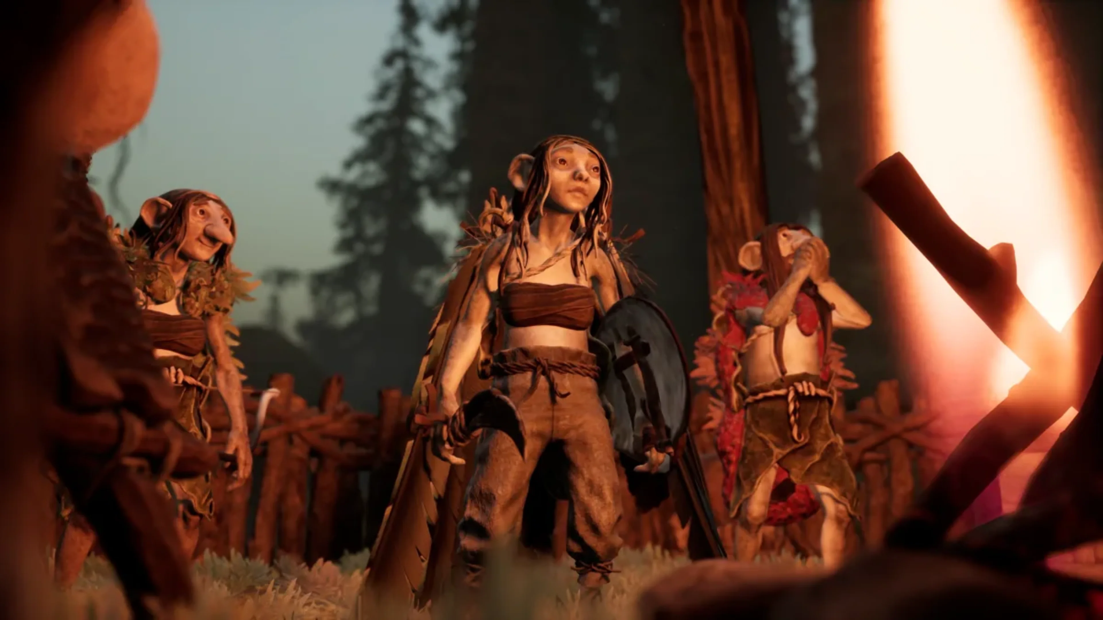 Three gnome characters wearing rustic clothing and carrying equipment stand beside a bright fire in Trollheim: Gnomes.