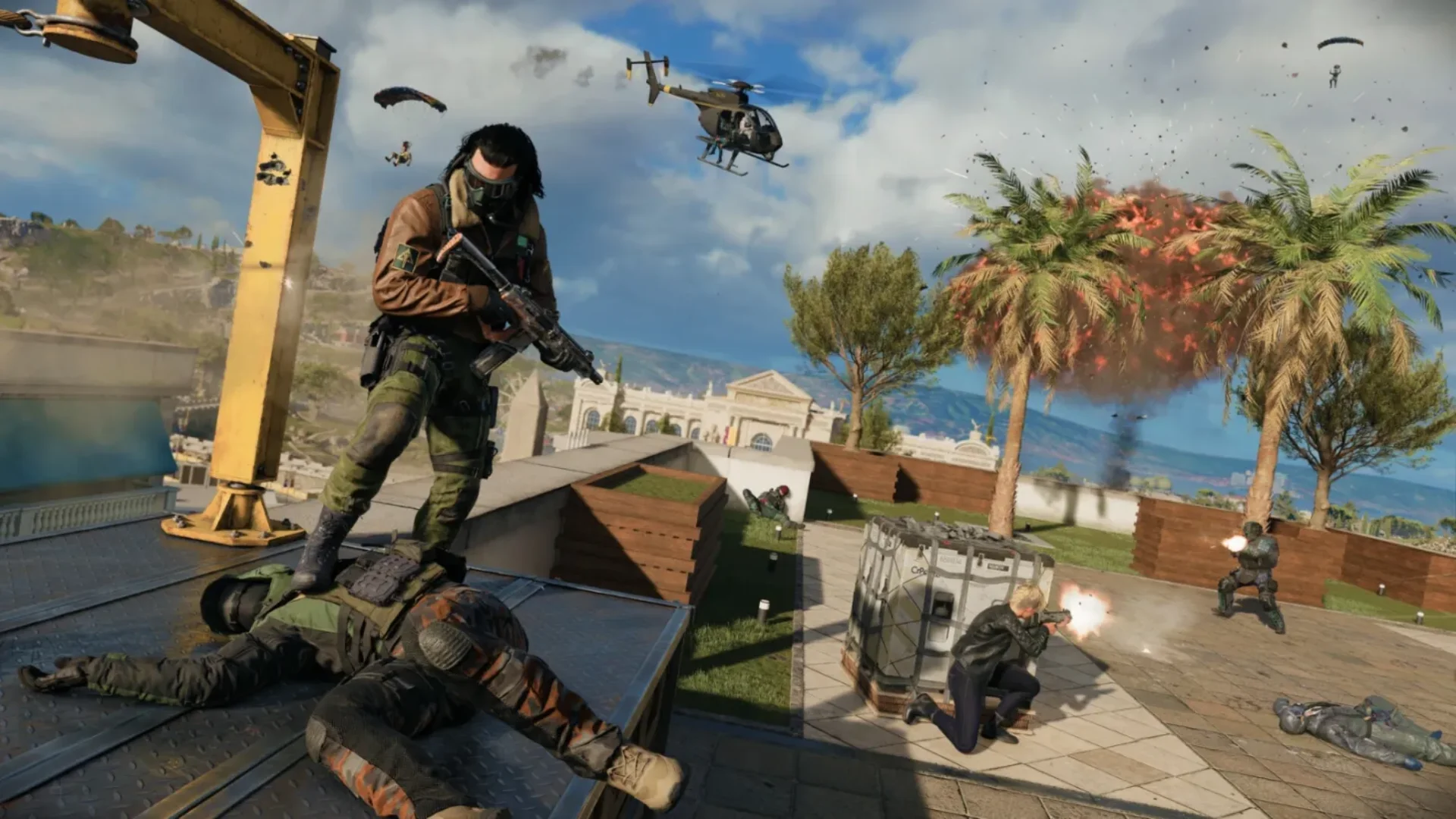 Warzone soldiers fight across a rooftop as a helicopter flies overhead and an explosion erupts among palm trees.