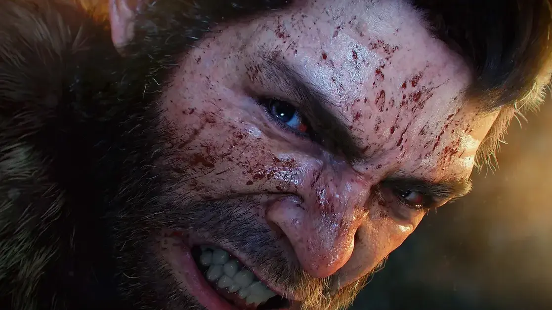 Close-up of a snarling, sharp-fanged character with blood smeared across his face in Marvel’s Wolverine.
